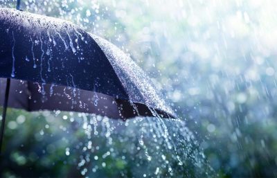 Ein Regenschirm, an dem Regenwasser abläuft. Schlechtwetterprogramm Linz