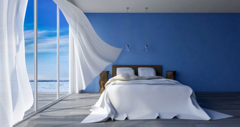 Bezogenes Wasserbett in einem Schlafzimmer mit zum Meer hin geöffneten Fenster. Wasserbetten Wien Preise.
