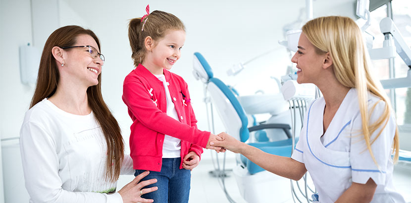 Mutter und Tochter in Behandlungszimmer bei Kinderzahnärztin.