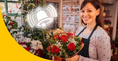 Blumenhändlerin mit Strauß Rosen in der Hand, über dem Strauß ist eine Benachrichtigungsglocke